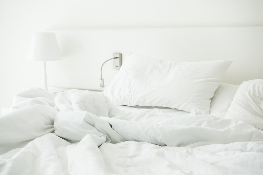 white-pillow-rumpled-bed_74190-4554