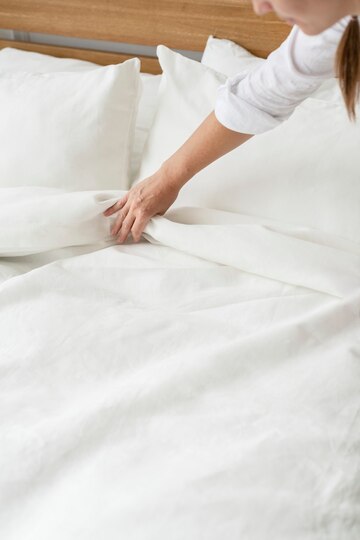 woman-making-bed-morning_53876-127301